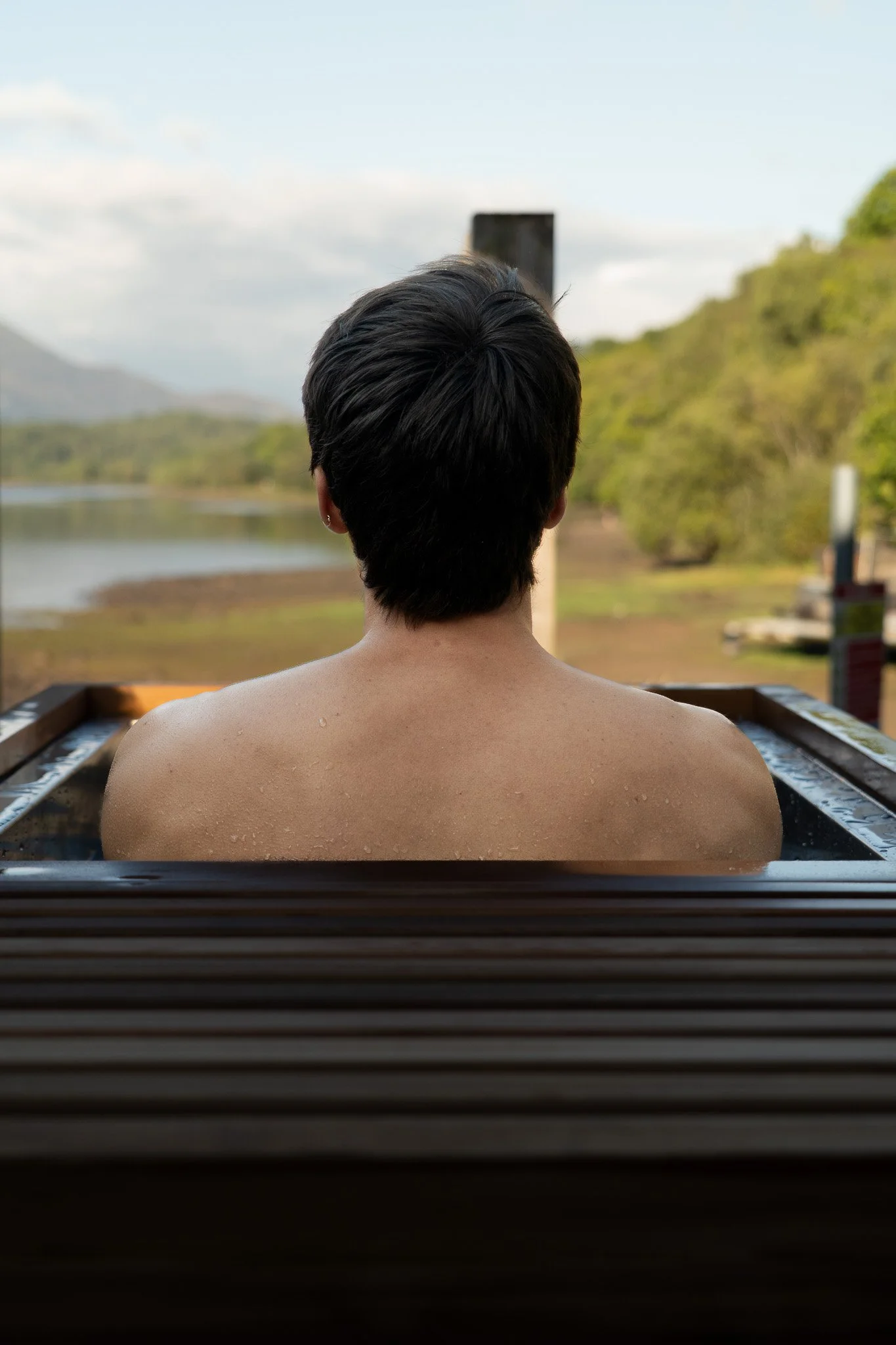 Guest taking a cold plunge at the wild spa